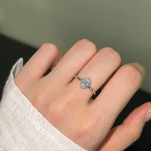 Close-up of a s925 silver ring featuring an oval cut gemstone worn on a finger