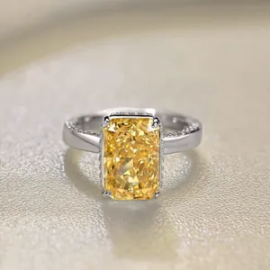 Macro shot of S925 silver radiant cut yellow zircon ring with micro-pave side stones