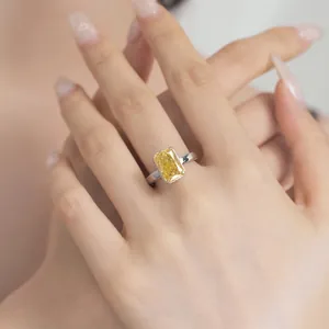 Macro shot of s925 silver ring featuring radiant cut yellow zircon on female hand