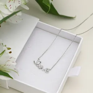 Close-up of S925 sterling silver Love necklace with heart zircon in a white jewelry box