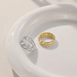 Macro shot of twisted rope design silver and gold rings with pavé cubic zirconia