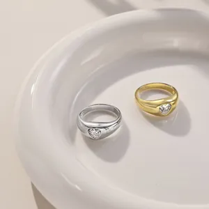 Detailed view of gold and silver S925 sterling silver rings with heart-shaped zircon