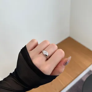 Close-up of S925 silver ring featuring a heart-cut zircon stone on model's hand