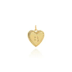 Detailed close-up of 18K gold-plated heart pendant with letter B and ribbed texture