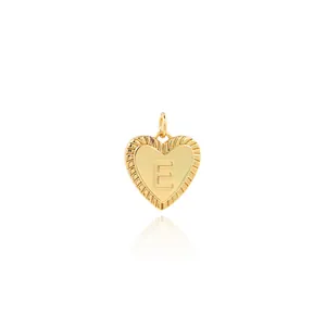Detail view of 18K gold plated heart pendant with letter E engraving and zircon accents