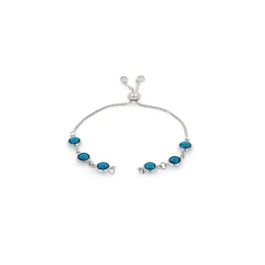 Detailed macro view of 18K gold plated bracelet with adjustable slide clasp and blue stones
