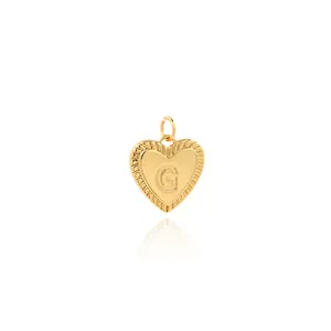 Detailed close-up of 18K gold plated heart pendant with zircon letter G engraving
