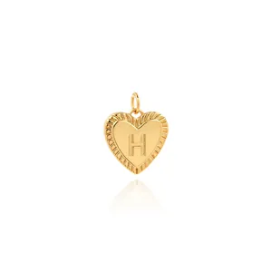 Macro shot of 18K gold plated heart pendant featuring letter H and zircon detail