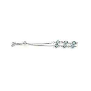 Adjustable silver bracelet featuring six round blue gemstones in a bezel setting