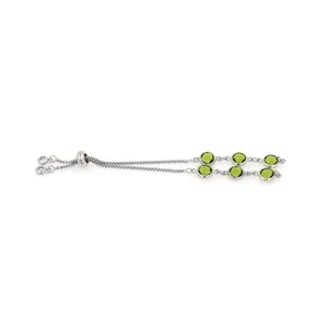 Detail of an adjustable 18K silver-plated slider bracelet with six green round gemstones