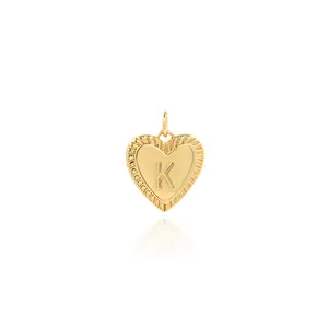 Detailed view of heart-shaped 18K gold-plated pendant with engraved letter K and wavy edge