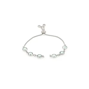 Detailed view of the adjustable bolo clasp and light green faceted gems on the silver bracelet