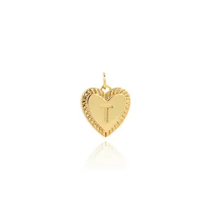 Detailed view of an 18K gold-plated heart pendant featuring a centered engraved letter T