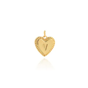 Detail of 18K gold-plated heart pendant featuring a 3D letter V with sunburst texture