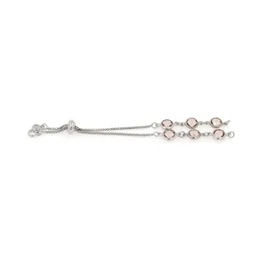 Macro shot of silver adjustable slider bracelet with pink round stones and box chain detail