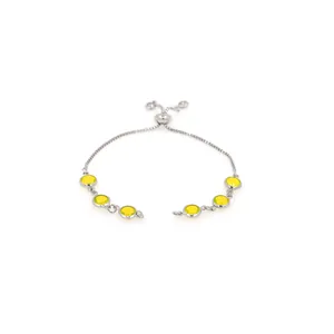 Macro shot of silver-tone bolo bracelet featuring six round yellow bezel-set gemstones
