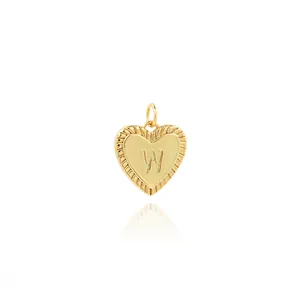Detail of 18K gold plated heart pendant with embossed letter W and zircon accents