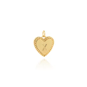 Close-up of 18K gold plated heart pendant with zircon X letter and ribbed edge detail