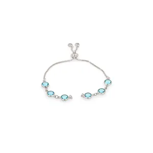 Close-up of adjustable silver bracelet featuring six bezel-set light blue gemstones