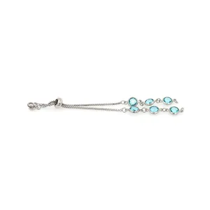 Detail of adjustable silver bolo bracelet featuring six faceted blue round gemstones