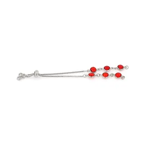 Macro detail of silver bolo bracelet featuring six faceted red gemstones and slider clasp