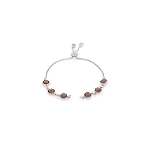 Macro detail of adjustable 18K gold-plated bolo bracelet with brown faceted gemstones