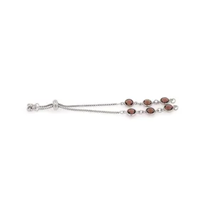Detail of adjustable silver box chain bracelet with six brown translucent gemstones