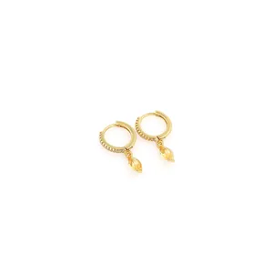 Close-up of 18K gold plated earrings with marquise-cut yellow gemstone and zircon pavé