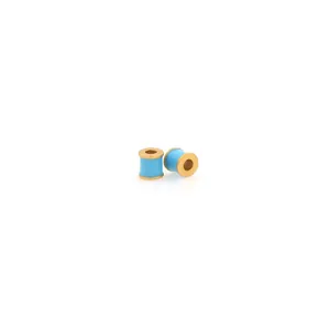 Macro detail of 18K gold plated cylinder beads with light blue enamel for DIY jewelry