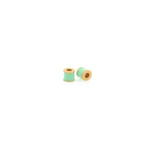 Detailed macro view of mint green enamel cylinder spacer beads with 18K gold plating