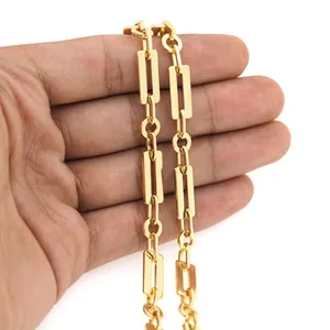 Close-up of 18K gold-plated rectangular and round link chain held by hand for DIY jewelry