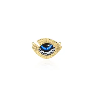 Macro detail of 18K gold plated evil eye pendant with textured finish and blue center