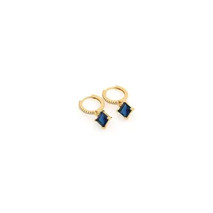Detail of 18K gold-plated earrings featuring a square blue sapphire and zircon micro-pave