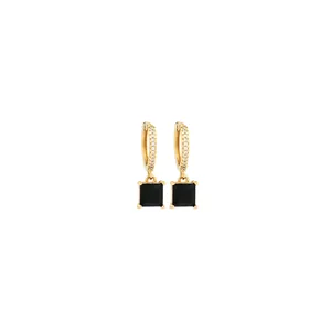 Detail of 18K gold-plated earrings featuring cubic zirconia and square black gemstone