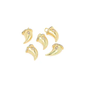 Detailed view of five 18K gold-plated horn pendants with pavé zircon and marquise-cut stones
