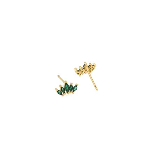 Detailed view of crown-shaped gold earrings with green marquise-cut zircon stones