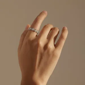 Detail of s925 silver pearl wreath ring with marquise zircon stones on finger