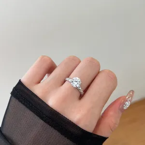 Macro view of sterling silver six-prong diamond ring with twisted pavé band detail
