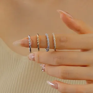 Detail of s925 silver twist rings and zircon paved bands stacked on a model finger