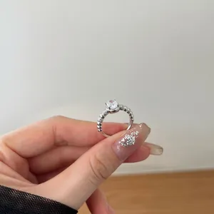 Macro detail of S925 sterling silver ring with oval zircon and beaded bubble band