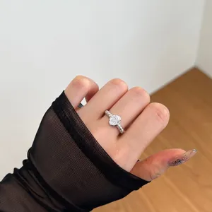 Detail of s925 silver ring with oval zircon and pave stones on black mesh gloves