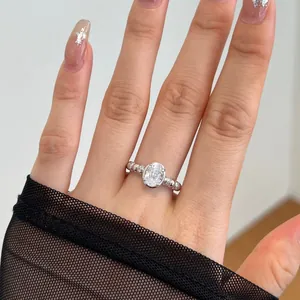 Detail of S925 silver ring with large oval zircon and beaded band on woman's finger