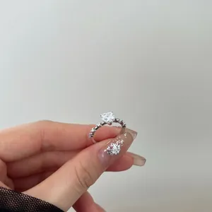 Macro shot of S925 sterling silver ring with heart-cut cubic zirconia and pave side stones