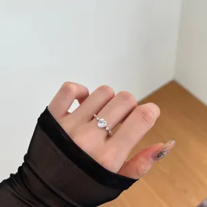 Close-up of s925 silver heart ring with sparkling cubic zirconia on a model's hand