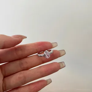 Close-up of pink oval gemstone ring with S925 silver beaded band and micro-inlaid stones