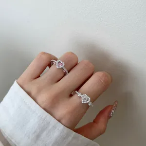 Elegant S925 sterling silver heart rings with pink and white zircon stones on a hand