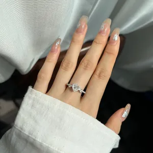 Close-up of S925 sterling silver ring with halo heart-shaped pink zircon on finger