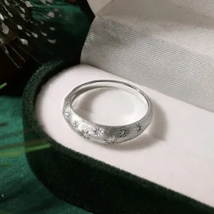 Close-up of s925 silver ring with brushed matte finish and starburst zircon details