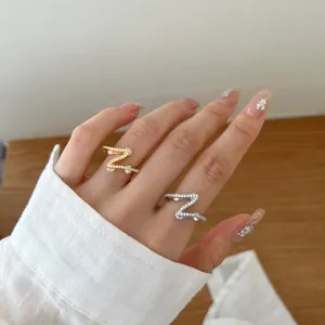 Elegant S925 sterling silver wave ring set with pink zircon on a gold and silver band