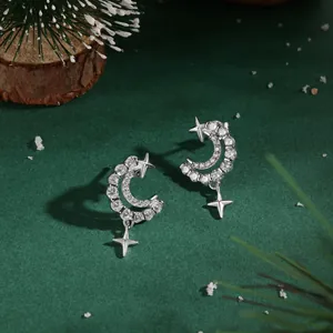 Macro view of S925 silver crescent moon earrings with cubic zirconia and star charms